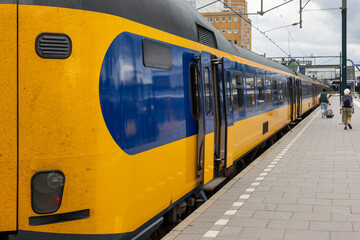 Railway platform with train ready for departure, Dutch city Groningen