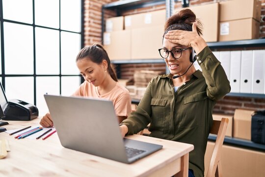 Young Mother And Daughter Working At The Office And Doing Homework Stressed And Frustrated With Hand On Head, Surprised And Angry Face