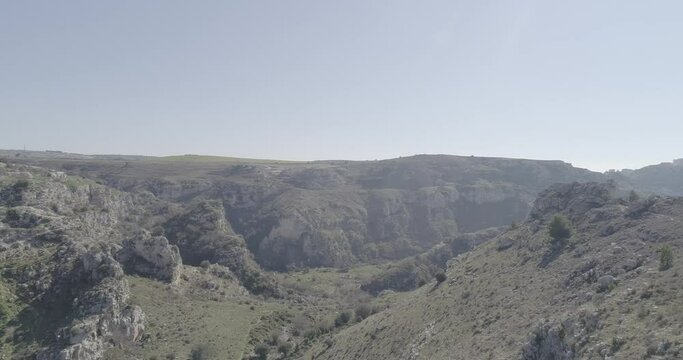 Aerial view of Matera 4K. Flying around the ancient city in Italy. White and old buildings remember Jerusalem. View of Murzia Materana and the paleolithic caves. Panoramic flying. 