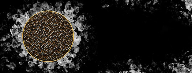 Tin of Caviar on ice on black background on banner format
