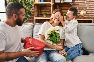 Fototapeta premium Family surprise mother with gift and flowers at home
