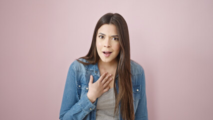 Fototapeta premium Young beautiful hispanic woman standing with surprise expression over isolated pink background