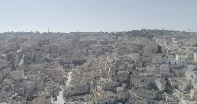 Aerial view of Matera 4K. Flying around the ancient city in Italy. White and old buildings remember Jerusalem. View of Murzia Materana and the paleolithic caves. Panoramic flying. 