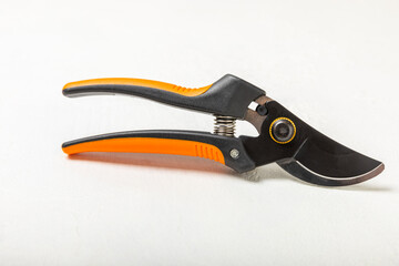 Garden tools on a light concrete background. Space for text. Space for copy. Top view. Gardening concept.Working in the garden.Hobby. Secateurs for pruning branches on a textured background.