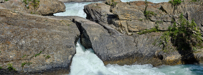 Panoramic image of the Natural Bridge as the Kicking Horse river flows beneath it