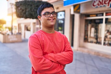 Down syndrome man smiling confident standing with arms crossed gesture at street
