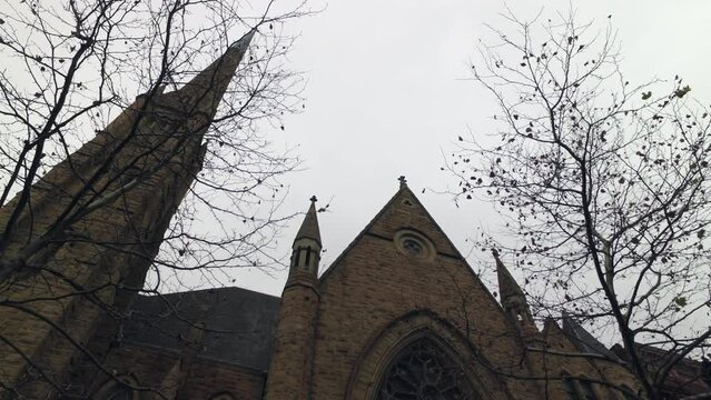 Aerial: Lockdown Of An Old Brownstone Church Entrance And Bell Tower On A Gray Day - New York, New York