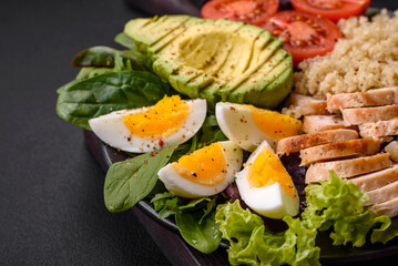 Delicious healthy lunch consisting of chicken, avocado, quinoa, eggs and tomatoes