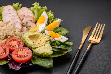 Delicious healthy lunch consisting of chicken, avocado, quinoa, eggs and tomatoes