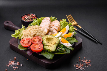 Delicious healthy lunch consisting of chicken, avocado, quinoa, eggs and tomatoes