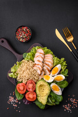 Delicious healthy lunch consisting of chicken, avocado, quinoa, eggs and tomatoes