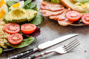 Delicious healthy lunch consisting of chicken, avocado, quinoa, eggs and tomatoes