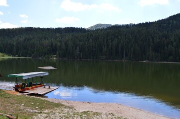 a small boat on a mountain lake