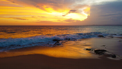Aerial view of the sunset on the beach on the ocean. Beautiful background for tourism and advertising. Tropical coast