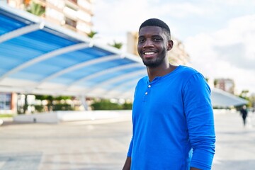 Young african american man smiling confident standing at street