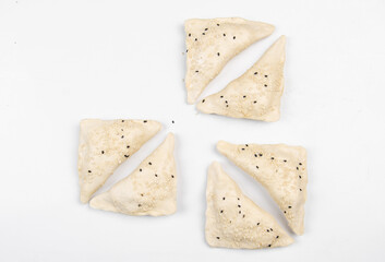 Frozen fresh samsa with black sesame on white background