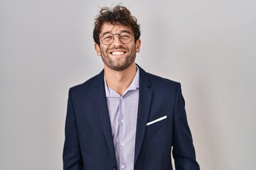 Hispanic business man wearing glasses with a happy and cool smile on face. lucky person.