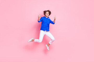 Fototapeta na wymiar Full body size cadre of young jumping overjoyed entrepreneur business woman thumbs up enjoy new her new job isolated on pink color background