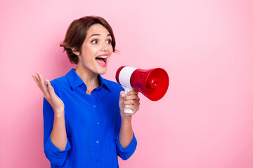 Photo of cheerful positive lady hand hold loudspeaker look say tell empty space isolated on pink color background