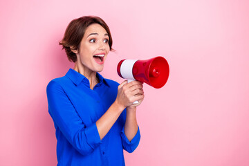 Portrait of positive overjoyed girl hands hold loudspeaker look speak talk empty space isolated on...