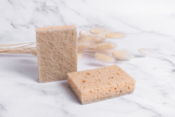 Sponges for washing dishes made of sisal. Two sponges and dried flowers. Double-sided sponges
