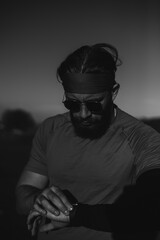 A determined athlete preparing for the start of training on the top of the mountain at sunrise.