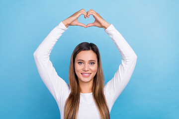 Fototapeta na wymiar Photo of glad stunning lady wear white clothes two arms above head demonstrate you heart shape isolated on blue color background