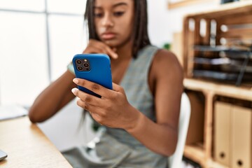 Young african american woman business worker using smartphone working at office