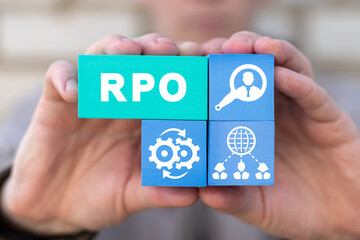 Businessman holding colorful styrofoam blocks with abbreviation: RPO. Concept of RPO - Recruitment...