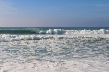 Naklejka na ściany i meble Waves in the ocean near Lisbon, Portugal on a sunny, windy winter day.