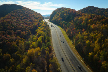 I-40 freeway road leading to Asheville in North Carolina thru Appalachian mountains with yellow...