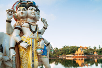 Three gods Dattatreya Trimurti (Divine Trinity) Sculpture in Grand Bassin Temple (Ganga Talao) on...