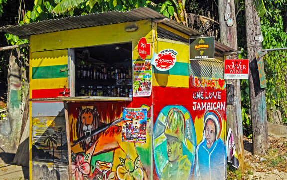 Negril, Jamaica - May 9. 2010: Fancy simple wooden beach store hut in rastafari reggae colors and culture symbols, jungle forest trees