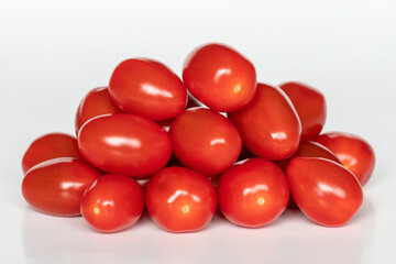 Small red cherry tomatoes on white background