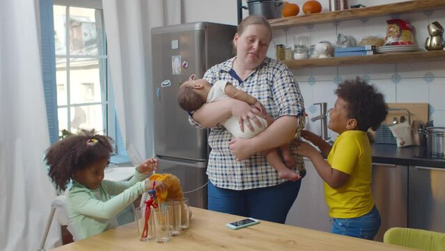 Tired caucasian nanny babysit three mixed-race noisy children. Realtime