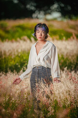 Beautiful asian young colorful hair lady at the outdoors flowered field.