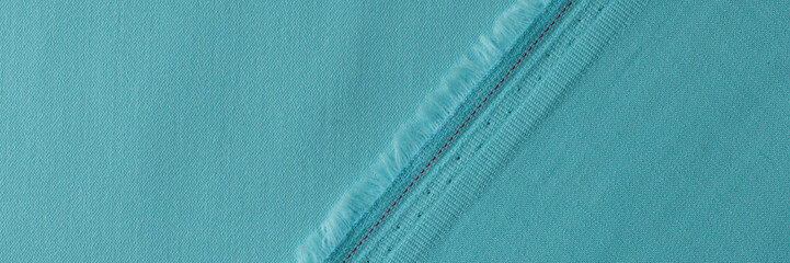 Light blue fabric with fringe and seam closeup