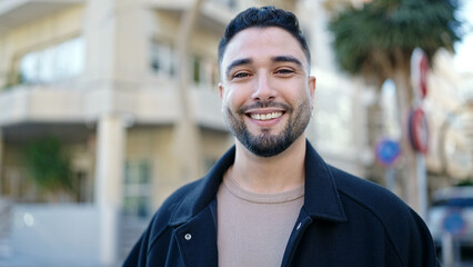 Young arab man smiling confident standing at street