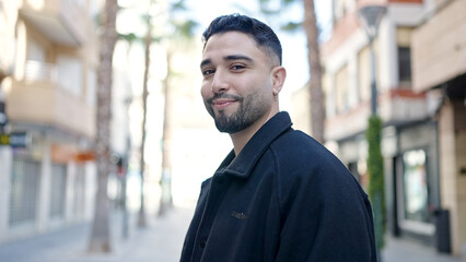 Young arab man smiling confident standing at street