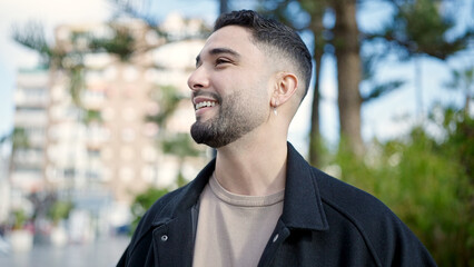 Young arab man smiling confident looking to the side at park