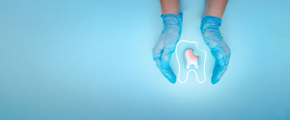 Woman hand holding unhealthy tooth white molar model with protective vortex around tooth on pastel...