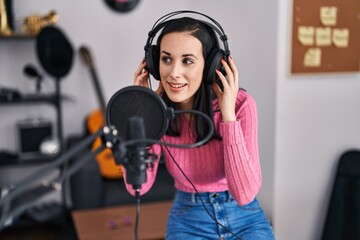 Young caucasian woman musician smiling confident singing song at music studio