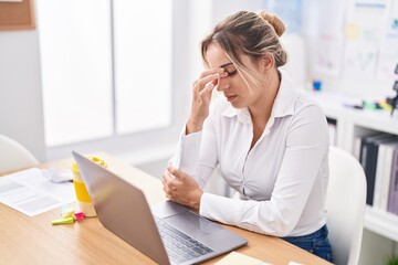 Young blonde woman business worker stressed using laptop at office