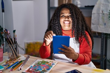 African american woman artist using smartphone drawing on notebook at art studio