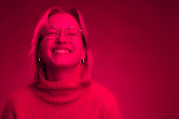 Portrait of a happy woman laughing. Monochromatic picture. Viva magenta.
