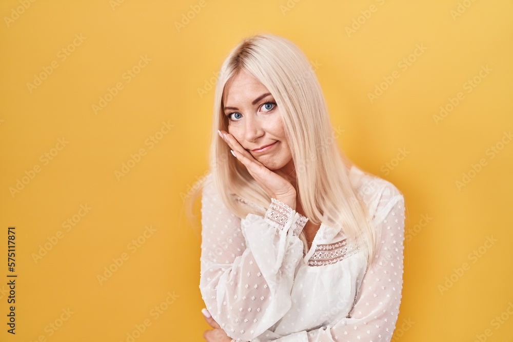 Canvas Prints Caucasian woman standing over yellow background thinking looking tired and bored with depression problems with crossed arms.