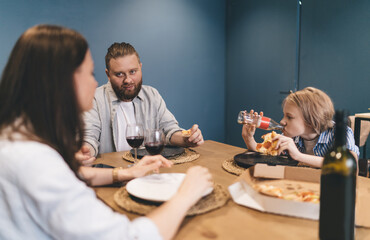 Family with kid enjoying delivered pizza