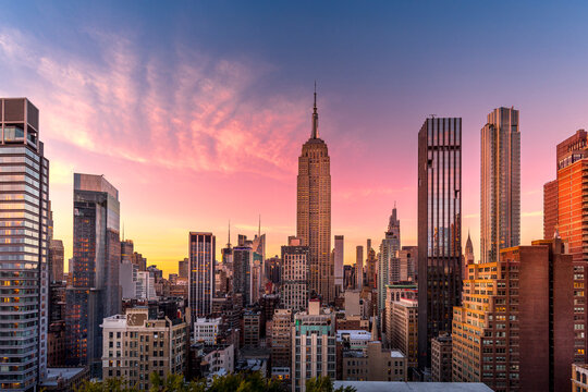 Fototapeta New York, USA - April 23, 2022: New York skyline at the end of sunset with Empire State Building in foreground