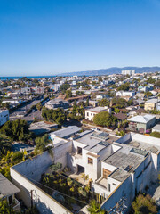Aerial view of Venice Beach, California. Picture taken on a sunny day with a drone, with the santa monica mountains and pacific ocean and beach seen in the background. 