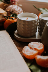 handmade scented candles, coffee, books and tangerines for the New Year. Cozy atmosphere of Christmas at home